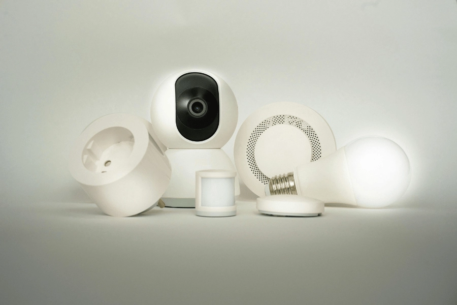 collection of home security equipment including camera, sensors, and doorbell